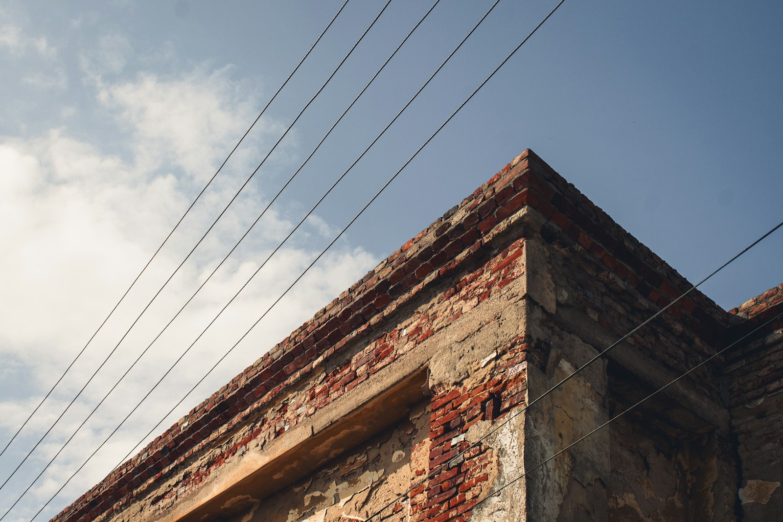 a brick building with power lines above it